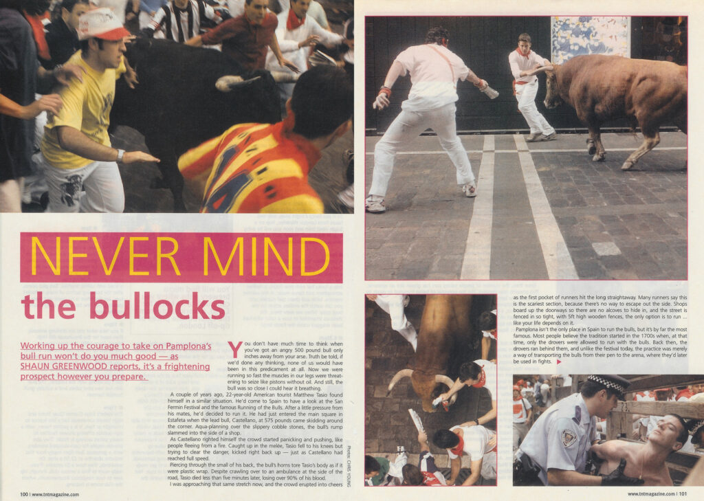 Runners in white and red sprint away from a charging black bull, alongside an article titled "Never Mind the Bullocks."